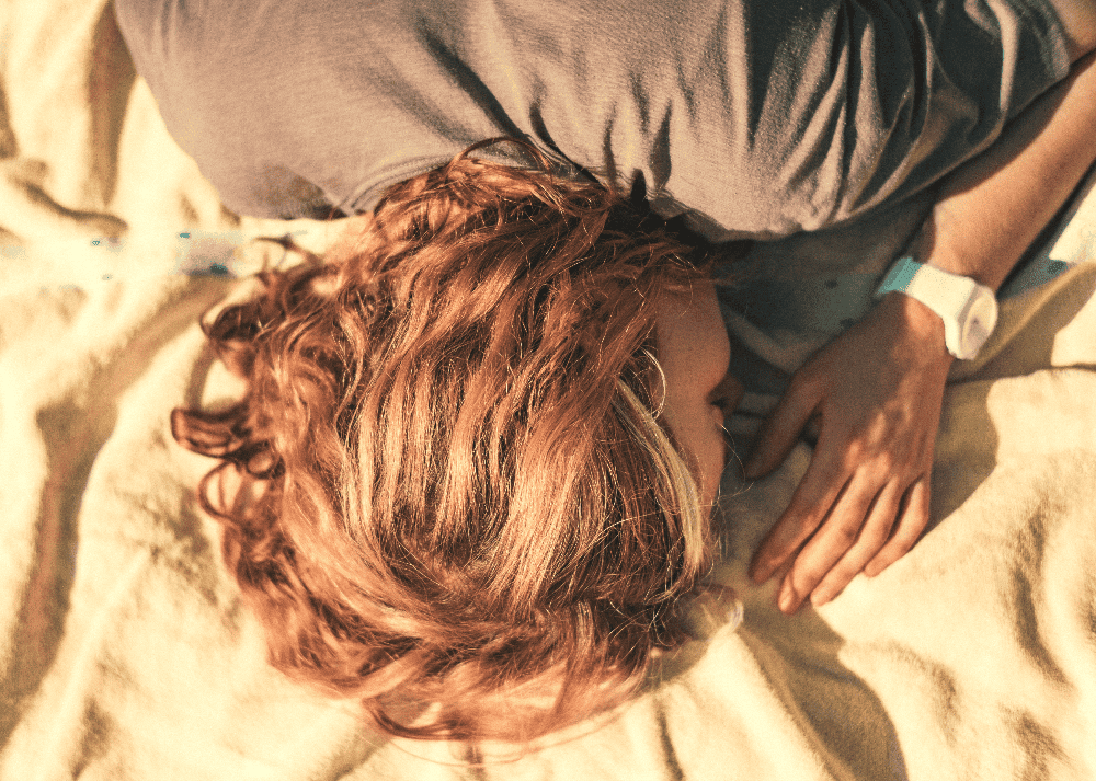 woman laying down on a bed