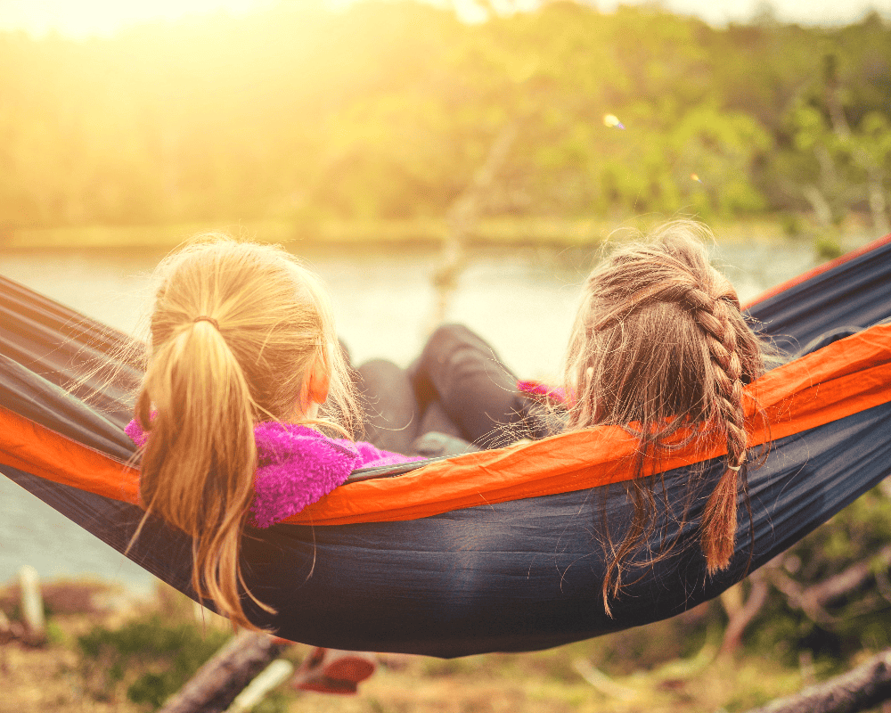 two sisters sitting in a hammock
