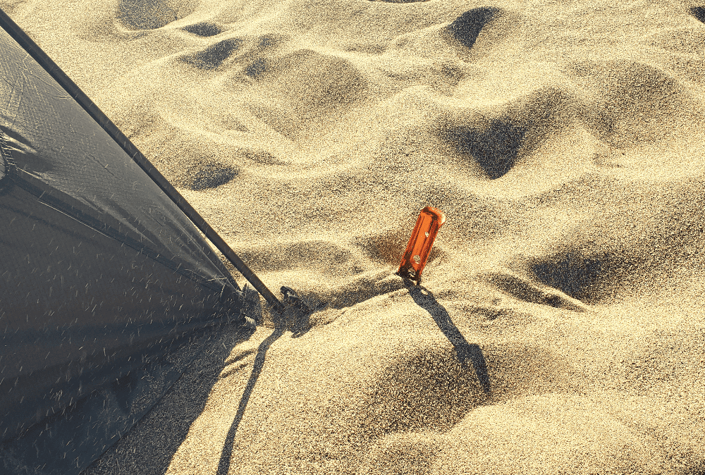 tent stake buried in the sand