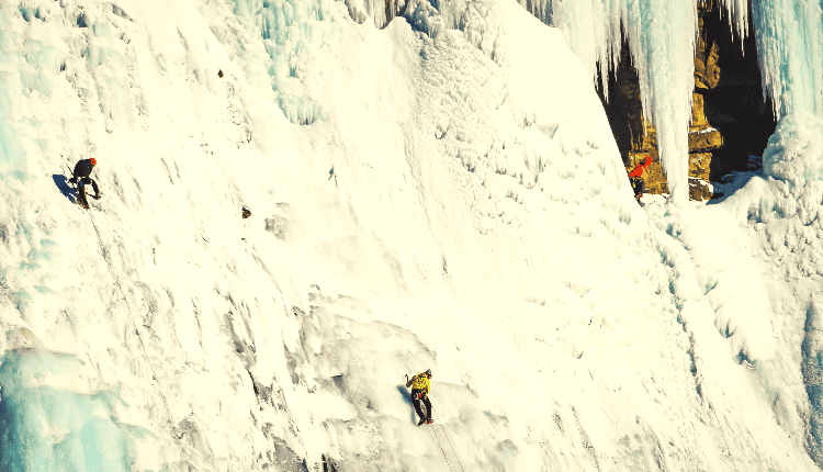 people ice climbing