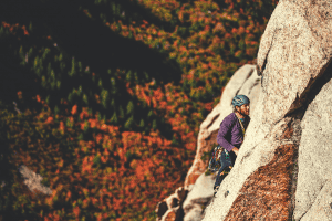 man trad climbing in fall