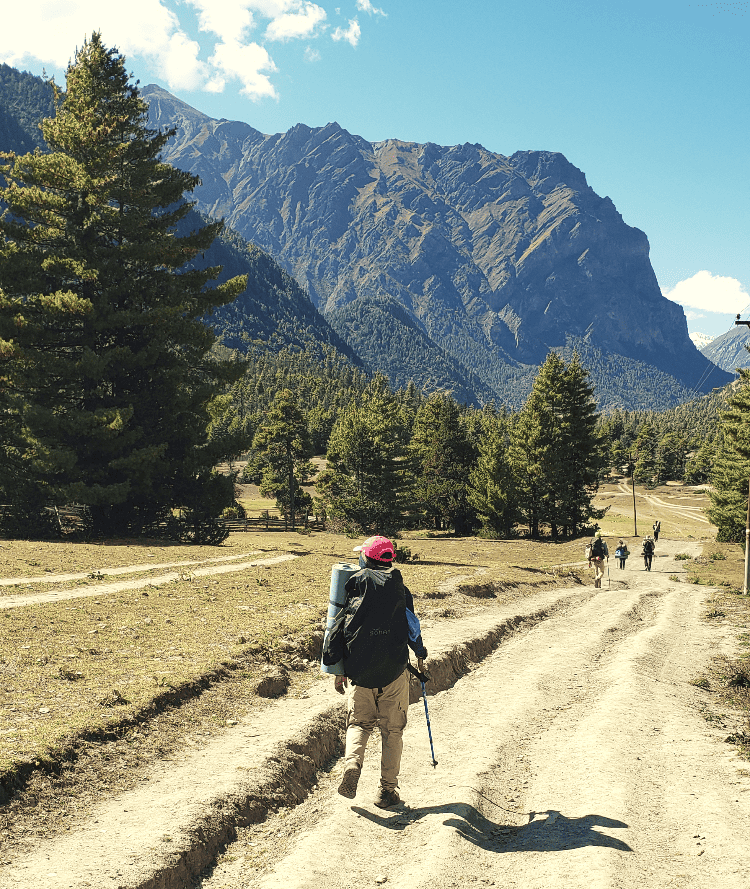 man walking through himalayas
