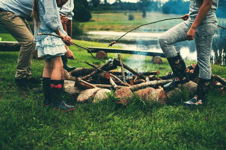 kids cooking over a campfire