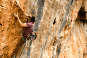 man in sunglasses climbing