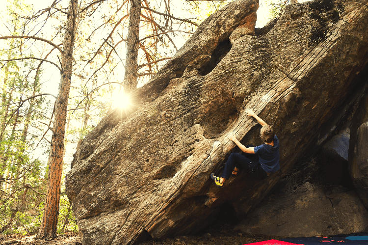 man bouldering in the sunrise