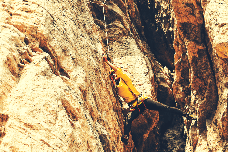 climber stretched out on a chimney route