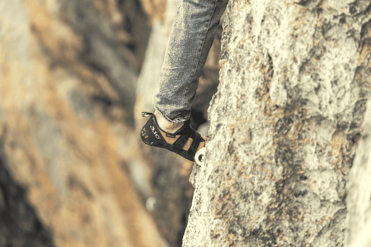 person wearing rock climbing shoes