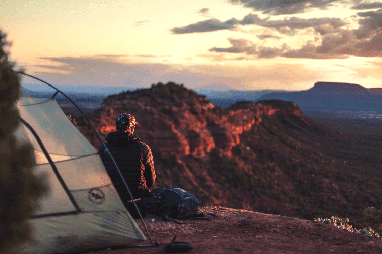 man camping in the sunset