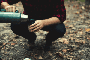 man pouring coffee into a mug