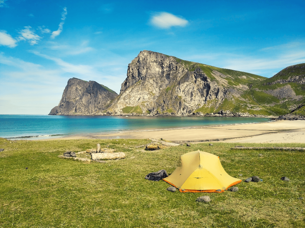 tent on flat ground by ocean