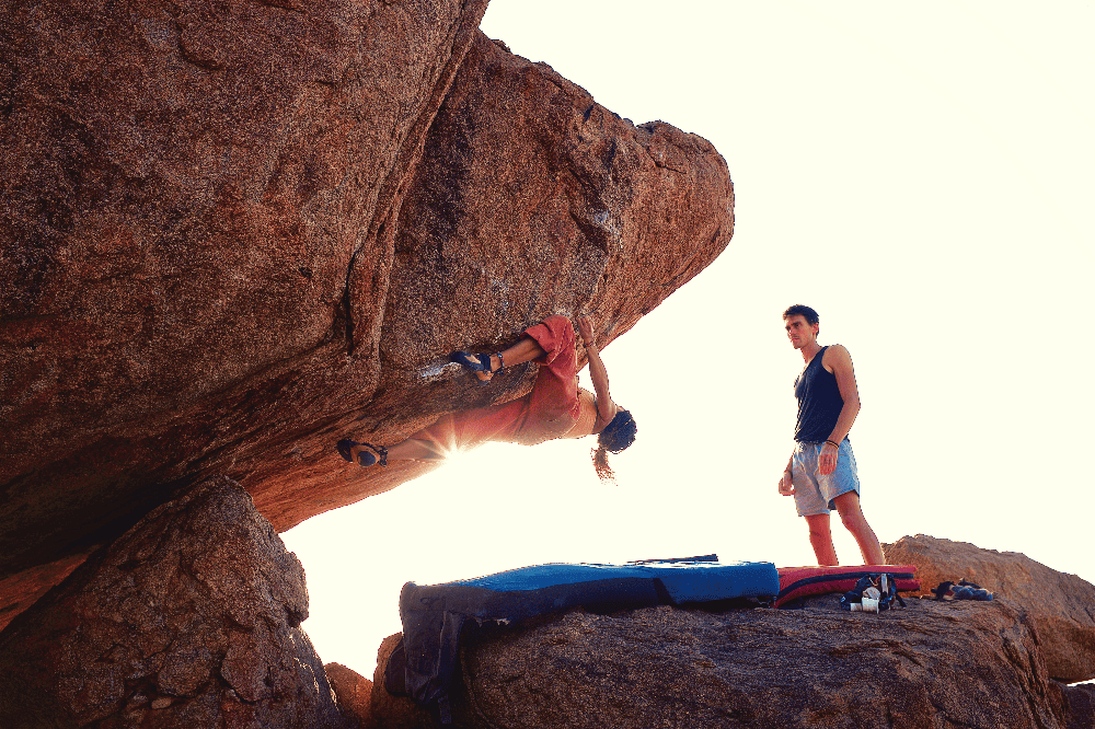 person climbing an overhang bouldering