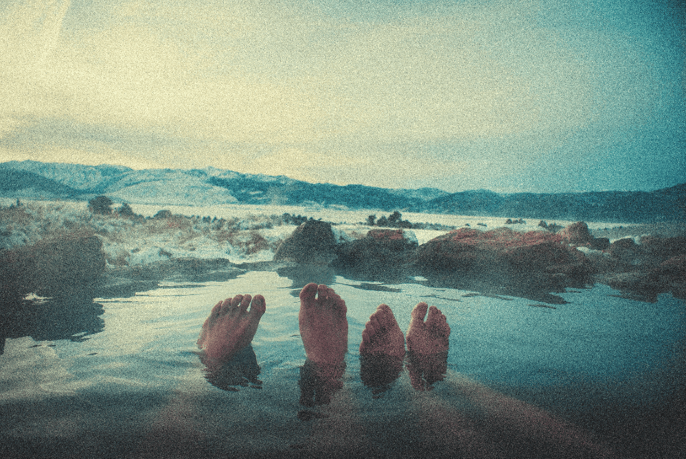 people soaking in a hot spring