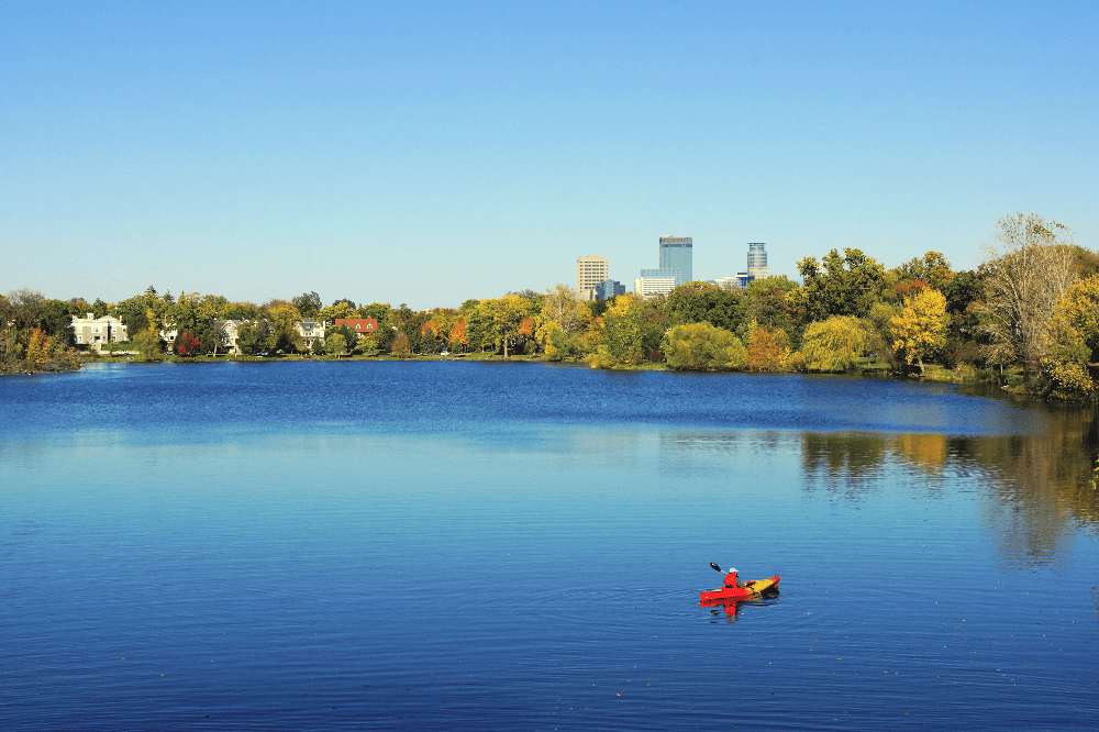 person kayaking on lake in minneapolis