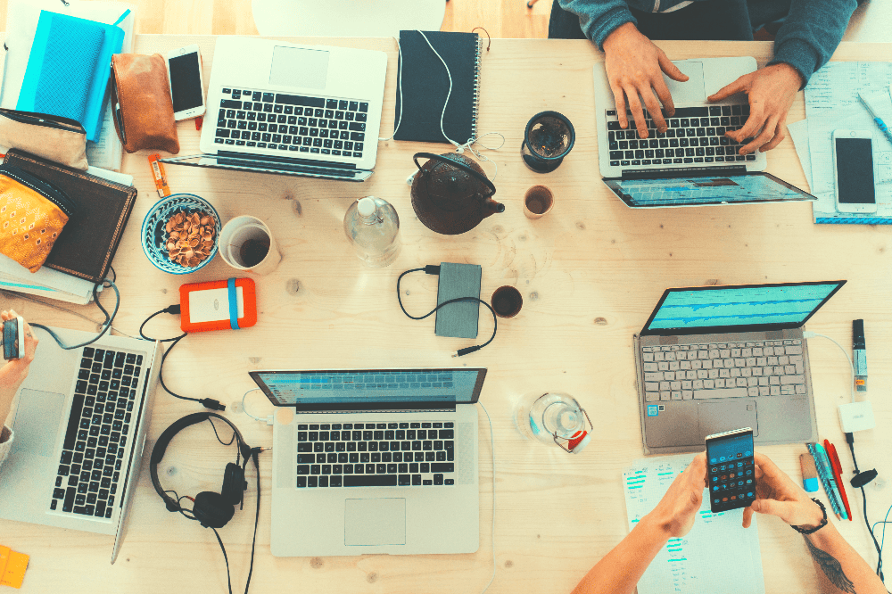 group of laptops on a desk for work