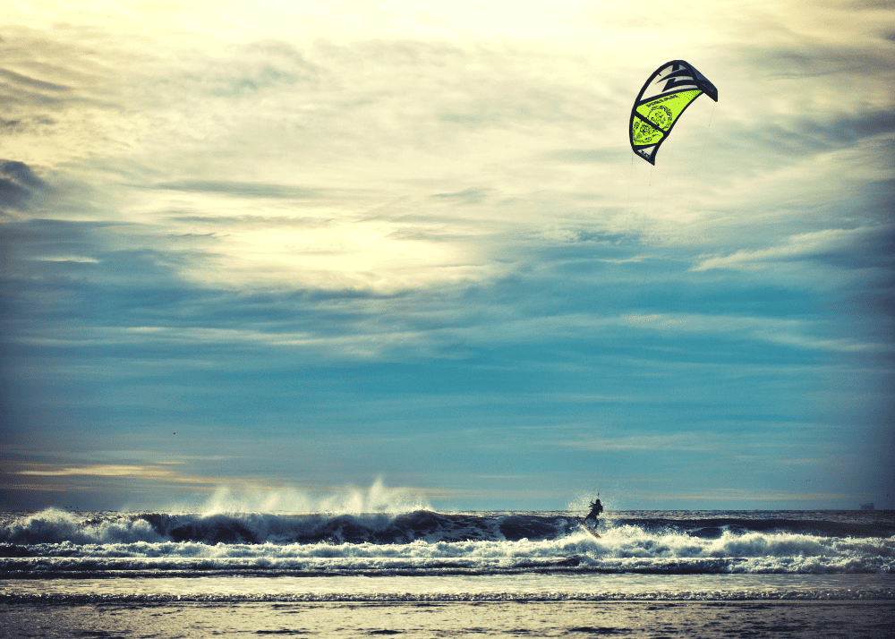 man windsurfing on a beach in california