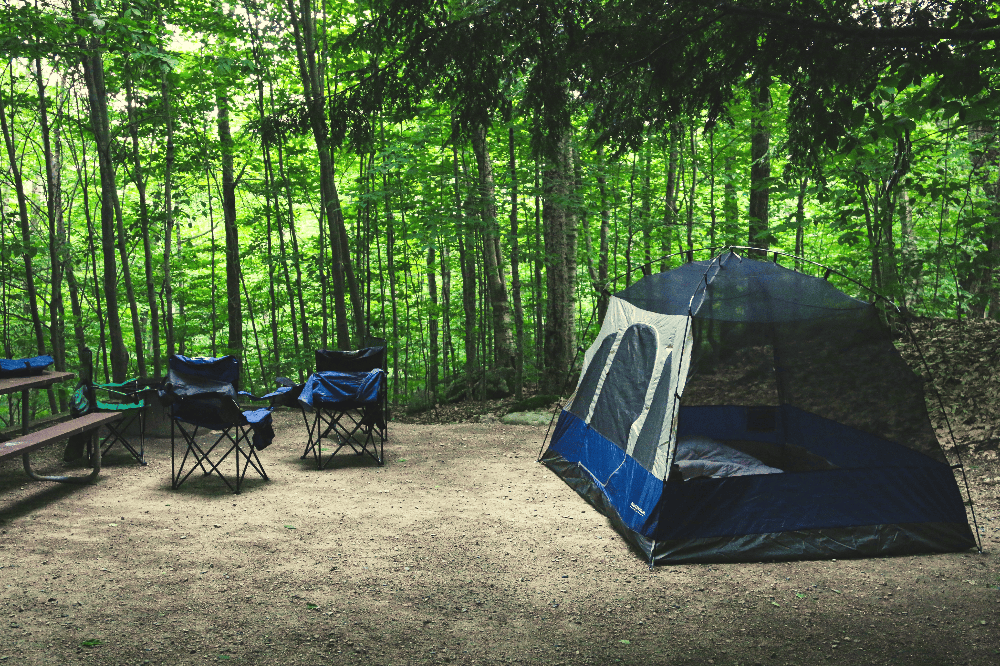 campsite with a blue tent and two chairs