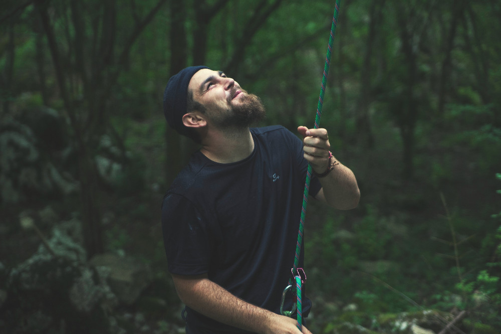 man belaying for rock climbing
