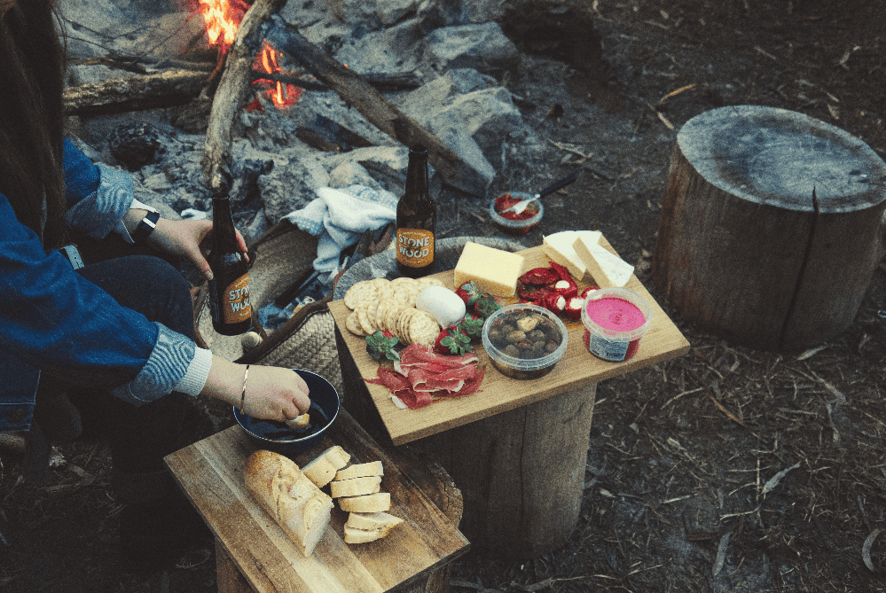 person preparing food over an open fire