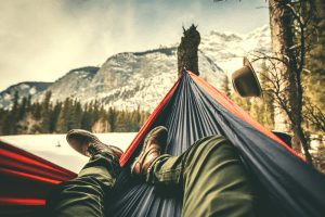 man laying in a hammock in the winter