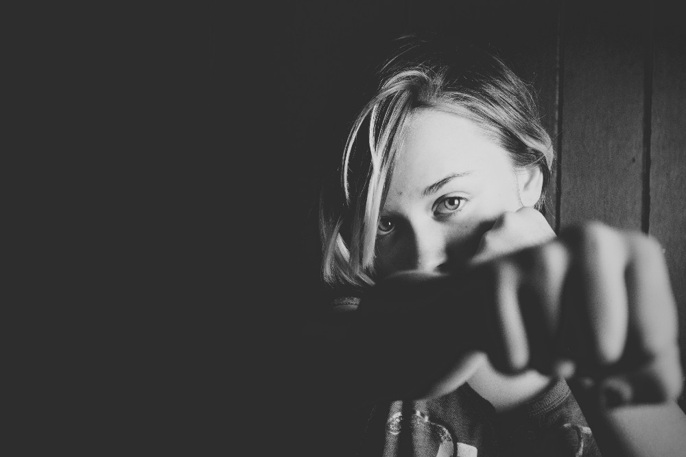 black and white photo of a woman punching the air