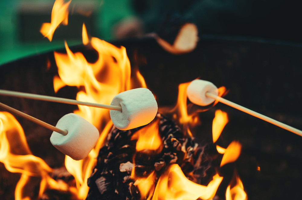 marshmallows roasting over an open fire
