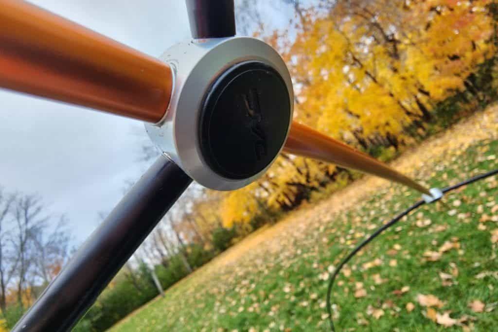 orange and black hub with poles for tent