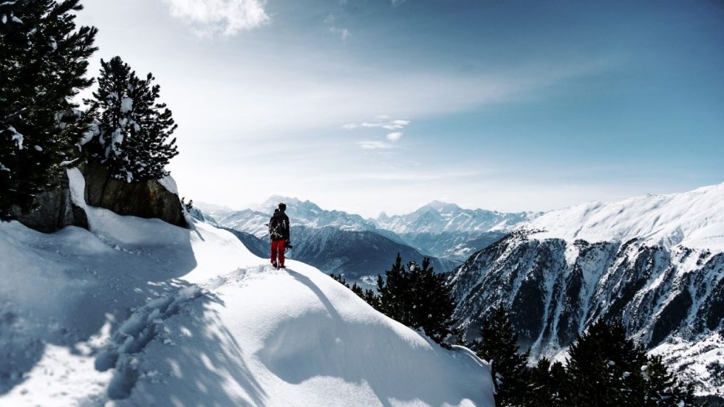 person hiking across a snowy mountain