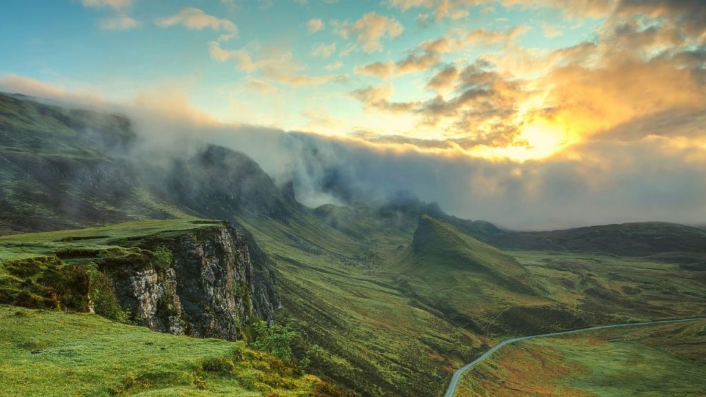 green landscape with mountains and a river