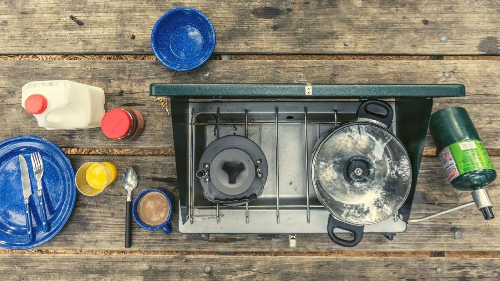 camping stove and propane with food ingredients on a table
