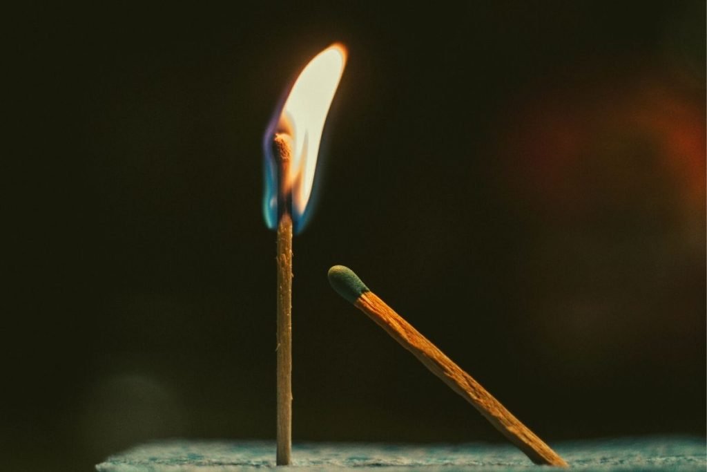 a lit match next to an unlit match