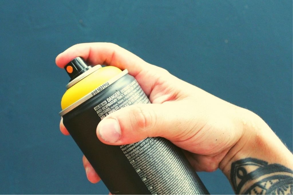 man holding an aerosol can