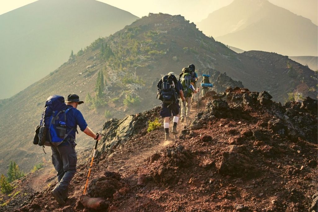 group of backpackers walking through a mountain ridge