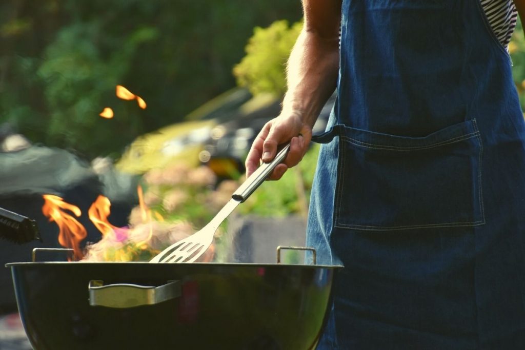 person grilling outside