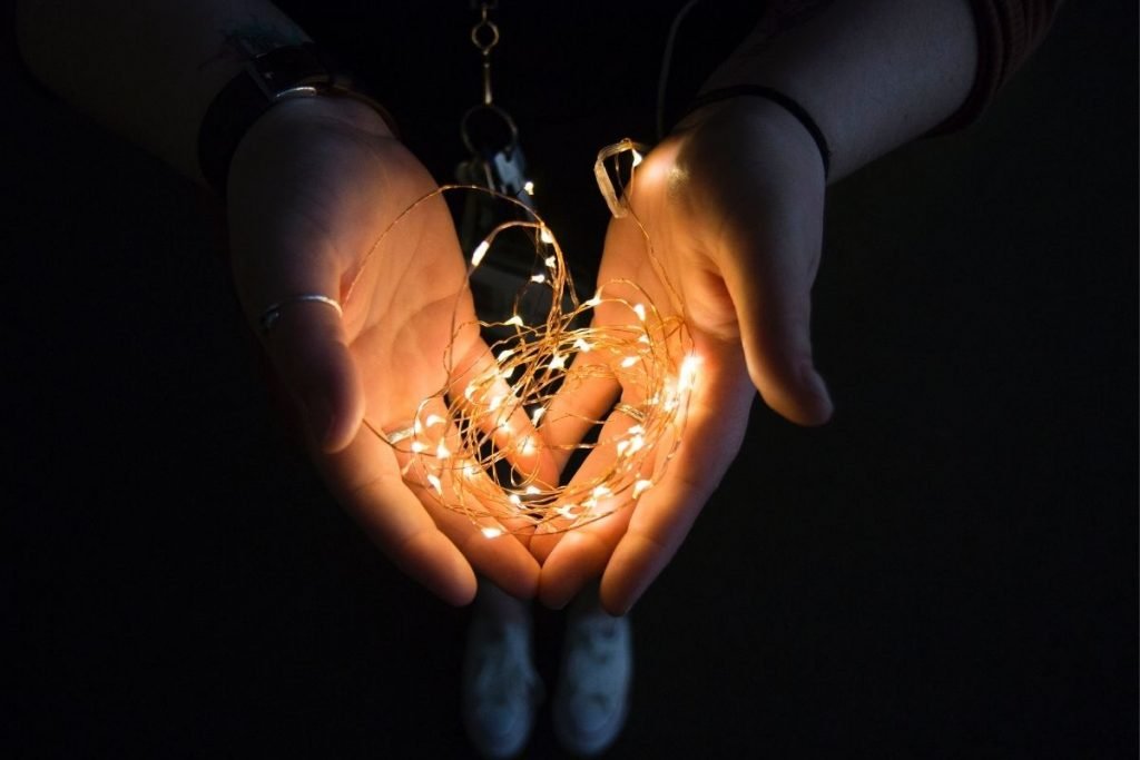 person holding string lights in their hands