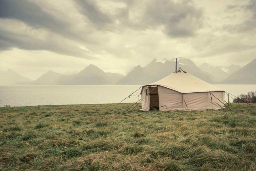 canvas tent with stove jack next to fjords