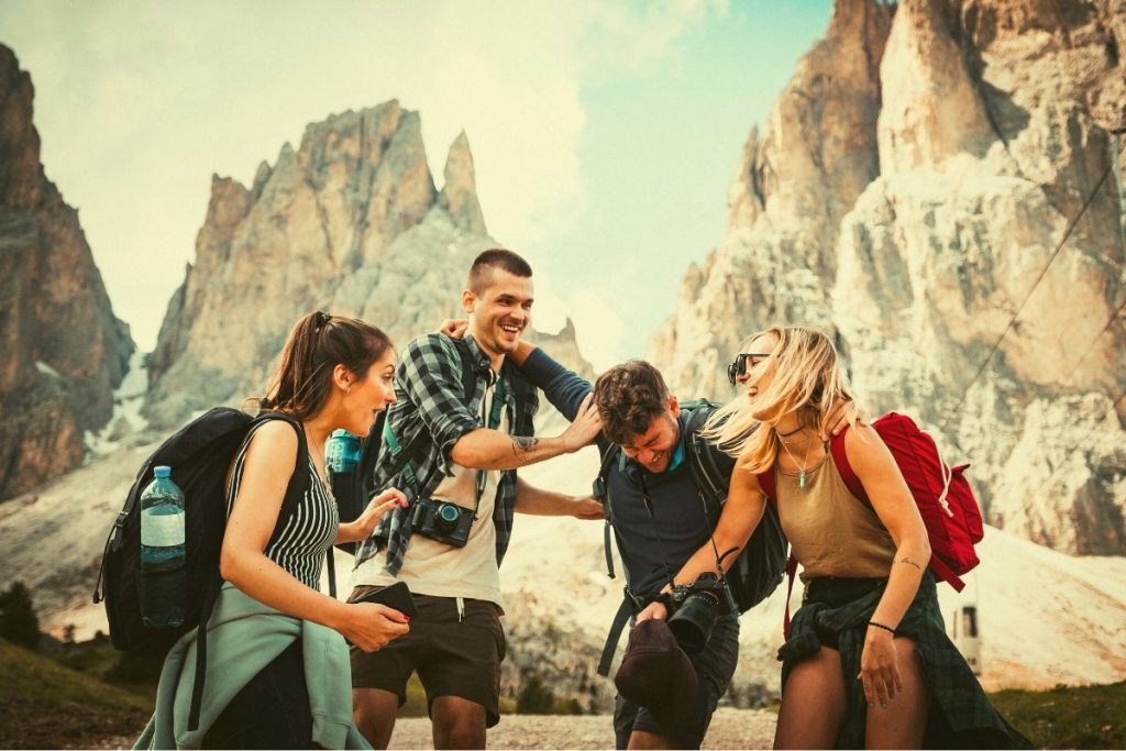 group of friends laughing in the mountains