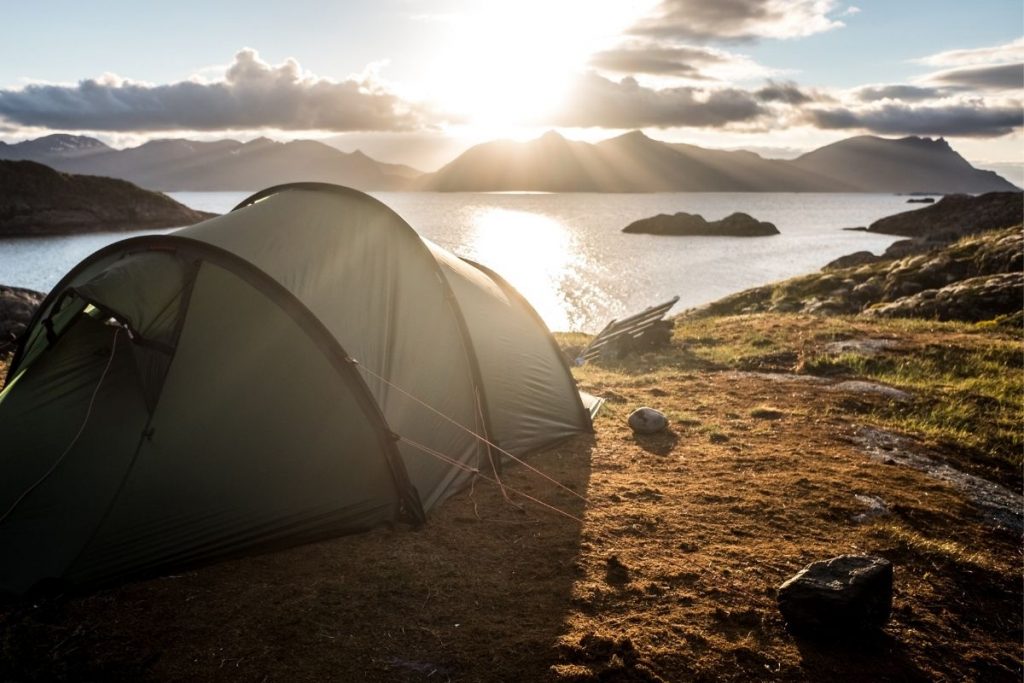 green popup tent in the norwegian fjords
