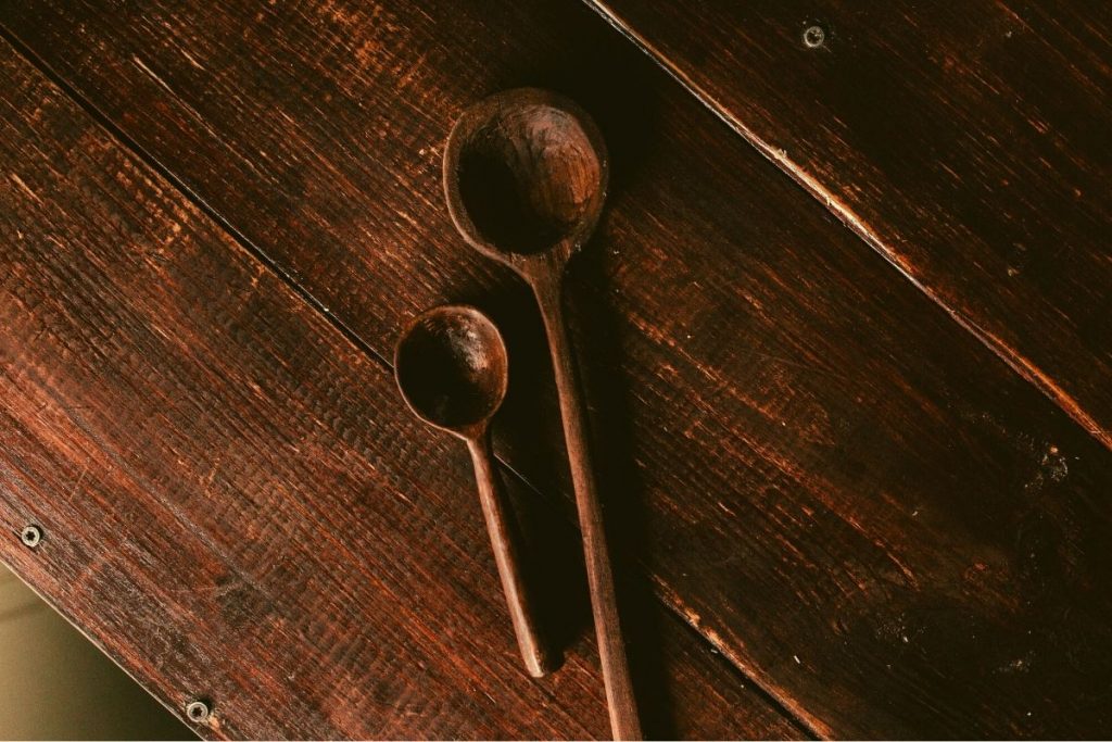 two wooden spoons on a wooden table