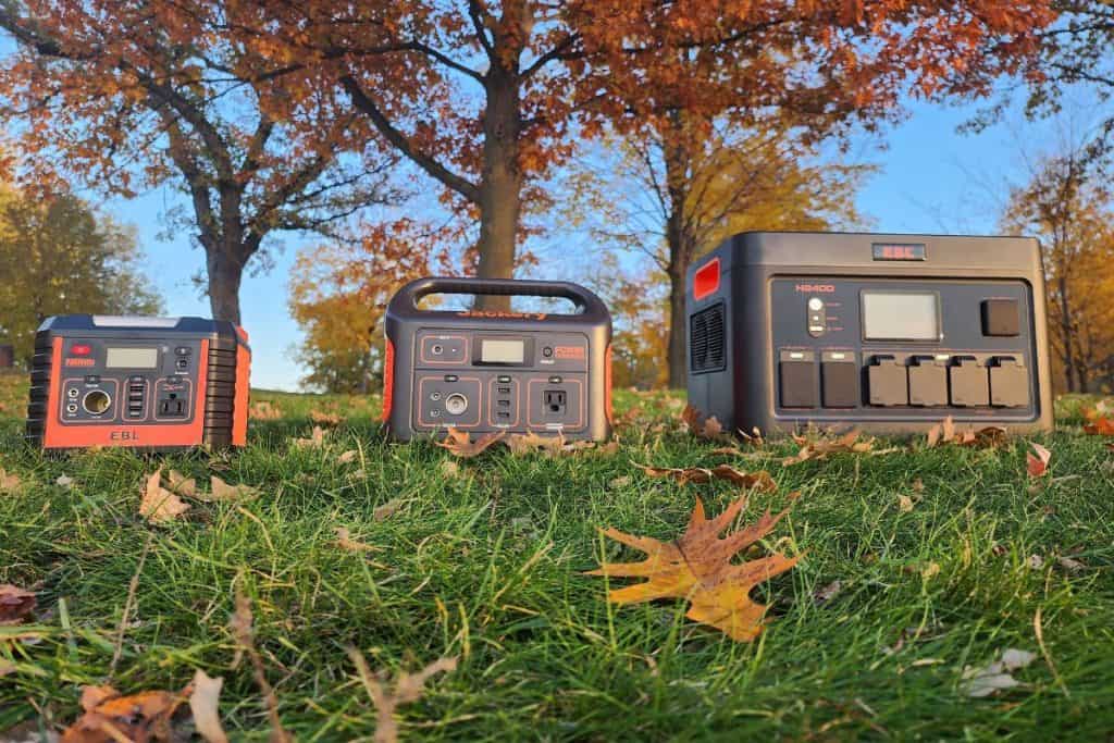three orange and black power stations on the grass during autumn