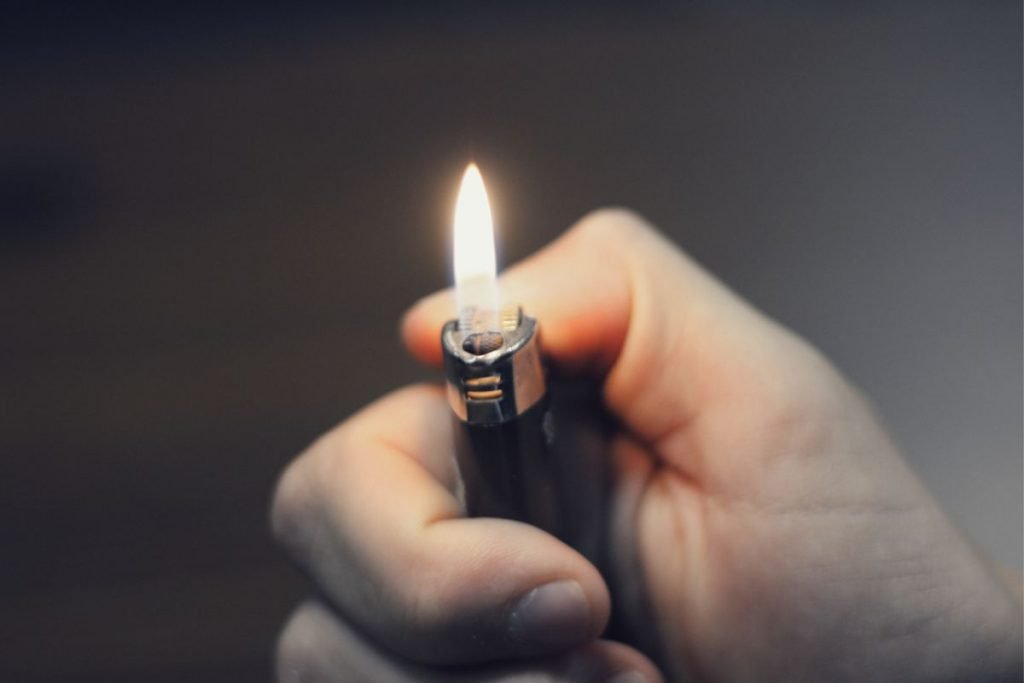lighter in hand gray background