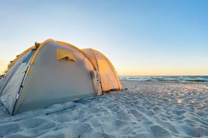 white tent on sand beach ocean