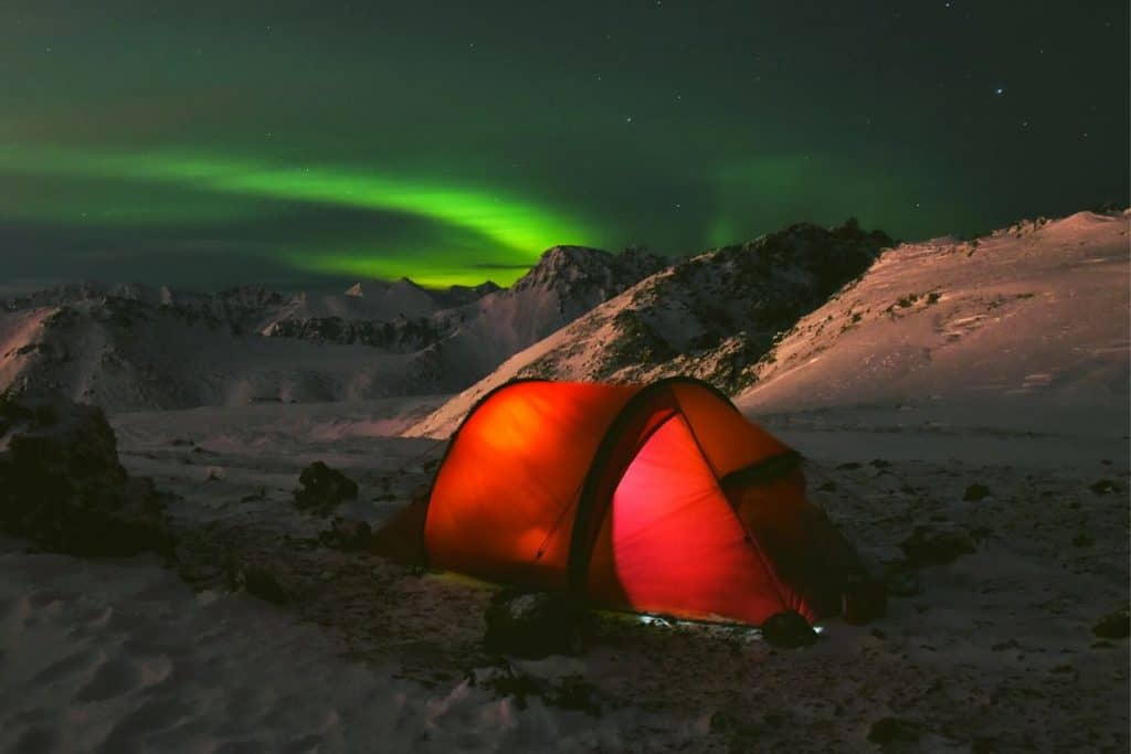aurora borealis red tent with light snow alaska