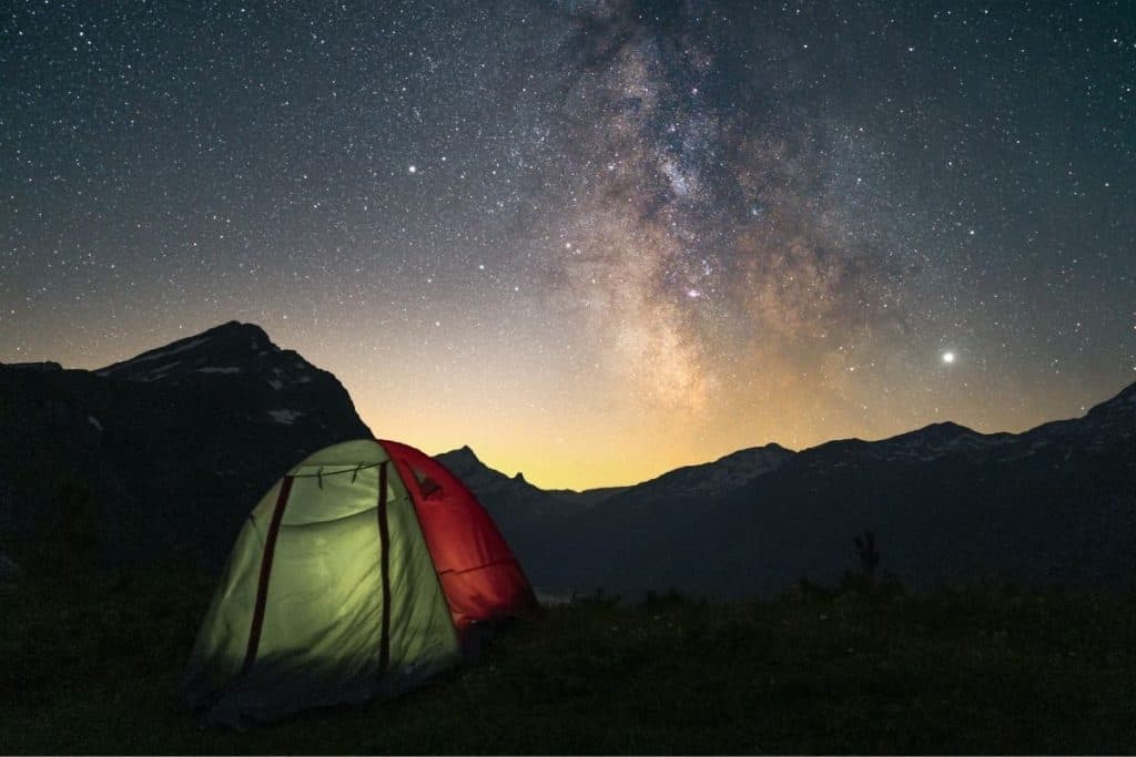 green and red tent under starry sky at night