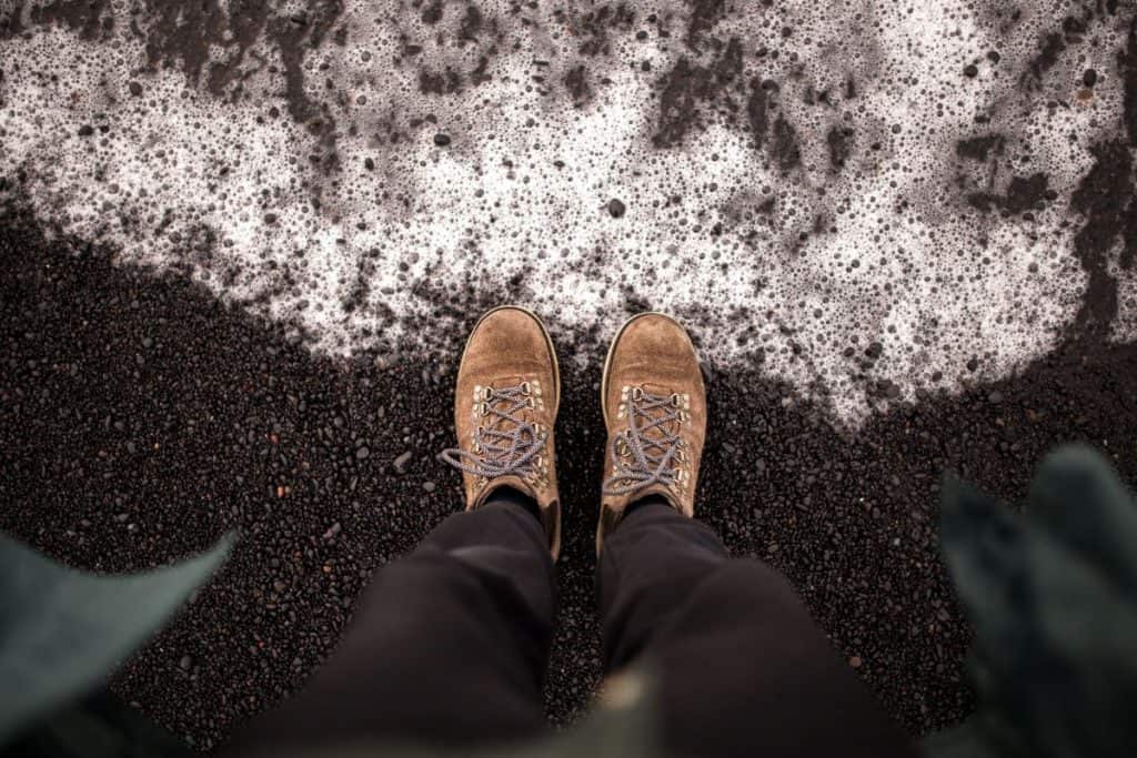 brown boots next to dirty snow
