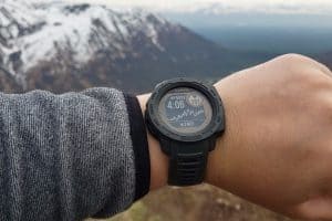 garmin watch on wrist of man in mountains