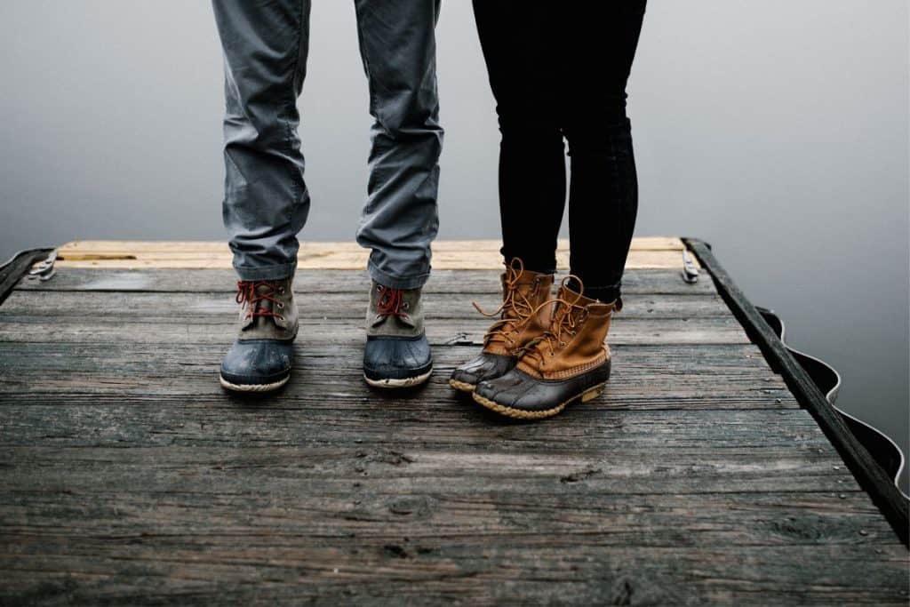 two people standing on a dock