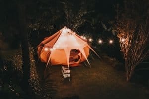 canvas yurt tent with string lights at night