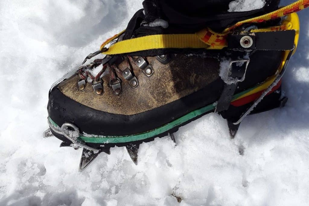boot on the snow with crampons