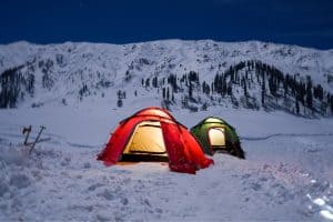 red and green tent on a snowy mountain