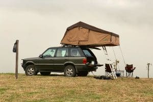 old jeep with a tent on the roof